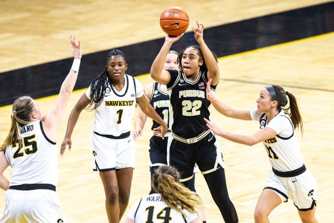 Purdue's Jelle Grant (22) attempts a basket as Iowa center Monika Czinano (25) and Iowa guard Megan Meyer (11) defend during a NCAA Big Ten Conference women's basketball game, Monday, Jan. 18, 2021, at Carver-Hawkeye Arena in Iowa City, Iowa.