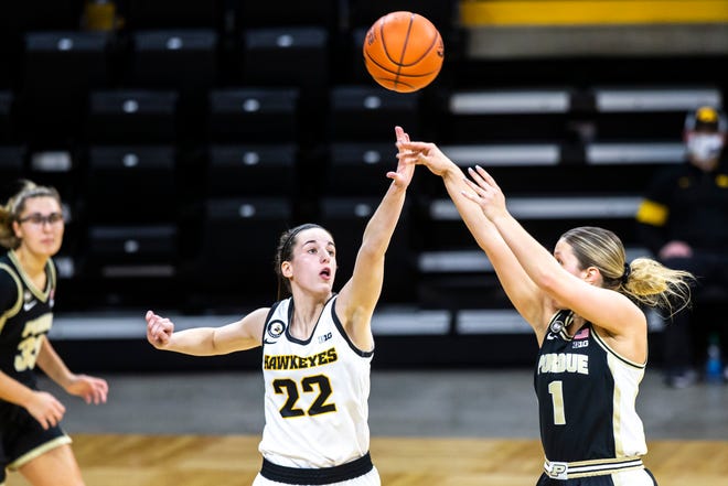 Purdue guard Karissa McLaughlin (1) makes a basket as Iowa guard Caitlin Clark (22) defends during a NCAA Big Ten Conference women's basketball game, Monday, Jan. 18, 2021, at Carver-Hawkeye Arena in Iowa City, Iowa.