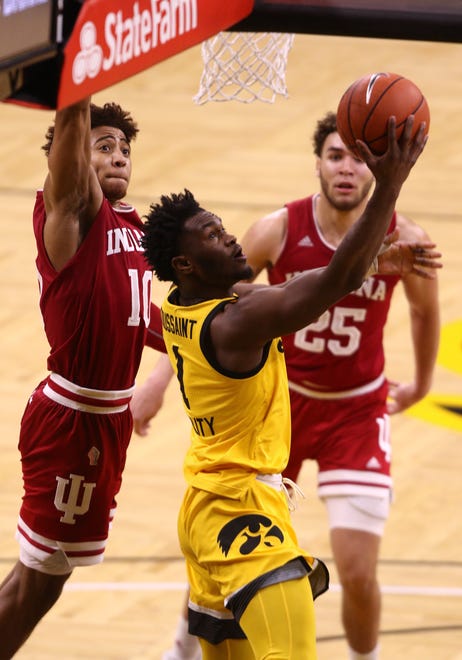 IOWA CITY, IOWA- JANUARY 21:  Guard Joe Toussaint #1 of the Iowa Hawkeyes goes to the basket during the second half in front of guard Rob Phinisee #10 and forward Race Thompson #25 of the Indiana Hoosiers at Carver-Hawkeye Arena on January 21, 2021 in Iowa City, Iowa.