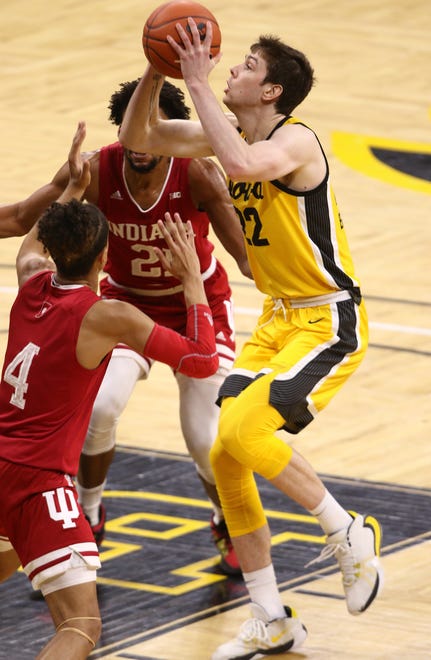 IOWA CITY, IOWA- JANUARY 21:  Forward Patrick McCaffery #22 of the Iowa Hawkeyes goes to the basket during the second half against forward Jerome Hunter #21  and Khristian Lander #4 of the Indiana Hoosiers at Carver-Hawkeye Arena on January 21, 2021 in Iowa City, Iowa.