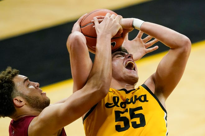 Indiana forward Race Thompson fights for a rebound with Iowa center Luka Garza (55) during the second half of an NCAA college basketball game on Thursday, Jan. 21, 2021, at Carver-Hawkeye Arena in Iowa City. Indiana won 81-69.