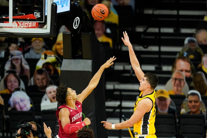 Iowa center Luka Garza shoots over Indiana forward Trayce Jackson-Davis, left, during the first half of an NCAA college basketball game, Thursday, Jan. 21, 2021, at Carver-Hawkeye Arena in Iowa City.