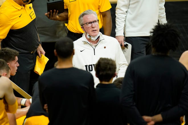 Iowa head coach Fran McCaffery, center, talks to his team during a timeout in the first half of an NCAA college basketball game against Indiana, Thursday, Jan. 21, 2021, at Carver-Hawkeye Arena in Iowa City.