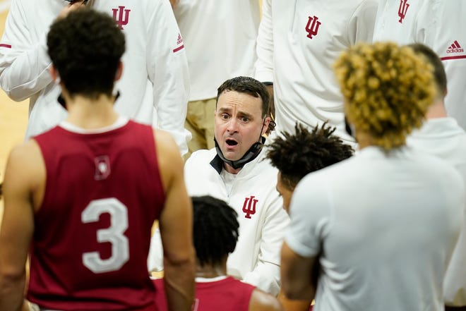 Indiana head coach Archie Miller, center, talks to his team during the first half of an NCAA college basketball game against Iowa, Thursday, Jan. 21, 2021, at Carver-Hawkeye Arena in Iowa City.