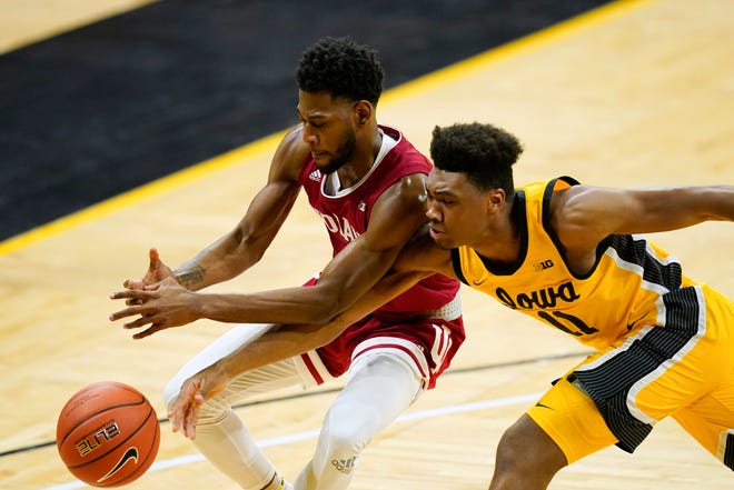 Iowa guard Tony Perkins tries to steal the ball from Indiana guard Al Durham, left, during the second half of an NCAA college basketball game on Thursday, Jan. 21, 2021, at Carver-Hawkeye Arena in Iowa City. Indiana won 81-69.