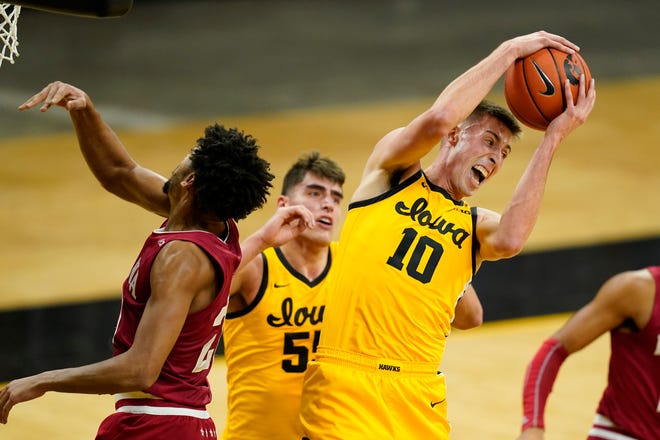Iowa guard Joe Wieskamp (10) grabs a rebound over Indiana forward Jerome Hunter, left, during the first half of an NCAA college basketball game, Thursday, Jan. 21, 2021, at Carver-Hawkeye Arena in Iowa City.