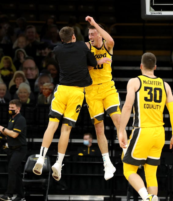 Iowa Hawkeyes guard Joe Wieskamp (10) celebrates a three point basket with guard Austin Ash (13) against the Indiana Hoosiers Thursday, January 21, 2021 at Carver-Hawkeye Arena.