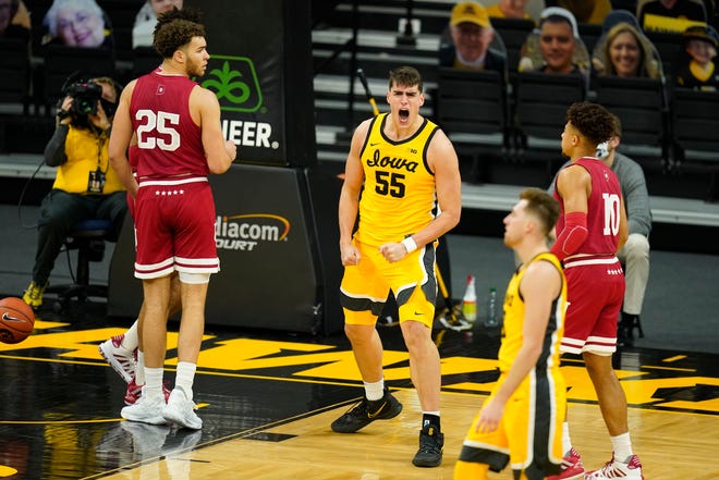 Iowa center Luka Garza (55) celebrates in front of Indiana forward Race Thompson (25) after making a basket during the first half of an NCAA college basketball game, Thursday, Jan. 21, 2021, at Carver-Hawkeye Arena in Iowa City.