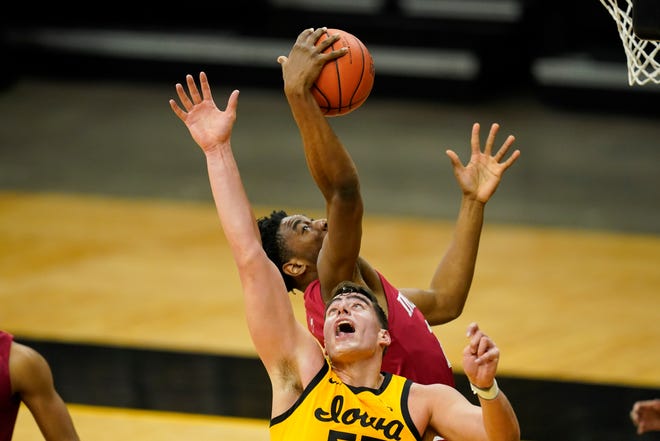 Indiana forward Jordan Geronimo, top, grabs a rebound over Iowa center Luka Garza during the first half of an NCAA college basketball game, Thursday, Jan. 21, 2021, at Carver-Hawkeye Arena in Iowa City.