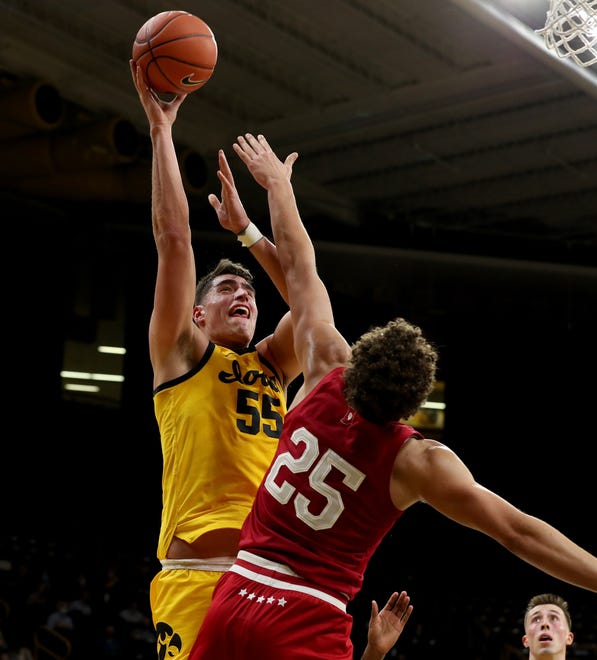 Iowa Hawkeyes center Luka Garza (55) puts up a shot over Indiana Hoosiers forward Race Thompson (25) Thursday, January 21, 2021 at Carver-Hawkeye Arena.