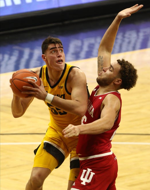 Forward Luka Garza #55 of the Iowa Hawkeyes goes to the basket during the first half against forward Race Thompson #25 of the Indiana Hoosiers on January 21, 2021, at Carver-Hawkeye Arena in Iowa City.