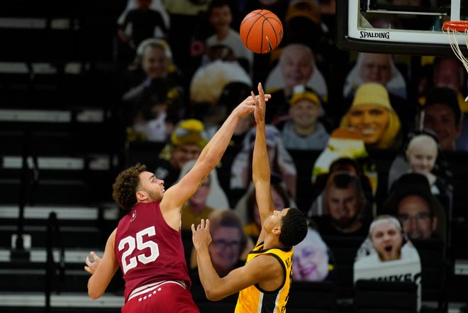 Indiana forward Race Thompson (25) is fouled by Iowa forward Keegan Murray during the second half of an NCAA college basketball game on Thursday, Jan. 21, 2021, at Carver-Hawkeye Arena in Iowa City. Indiana won 81-69.