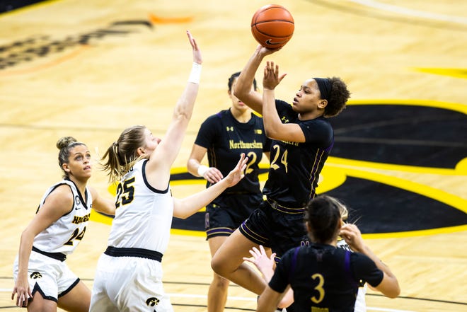 Northwestern guard Jordan Hamilton (24) makes a basket as Iowa center Monika Czinano (25) defends during the first half of a NCAA Big Ten Conference women's basketball game, Thursday, Jan. 28, 2021, at Carver-Hawkeye Arena in Iowa City, Iowa.