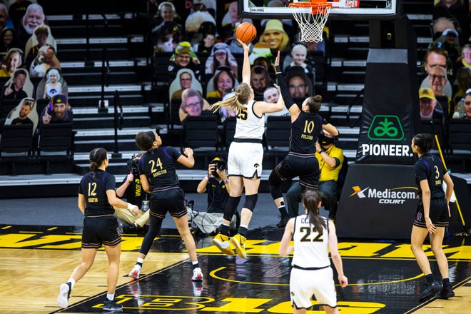 Iowa center Monika Czinano (25) makes a basket as Northwestern guard Lindsey Pulliam (10) defends during the first half of a NCAA Big Ten Conference women's basketball game, Thursday, Jan. 28, 2021, at Carver-Hawkeye Arena in Iowa City, Iowa.