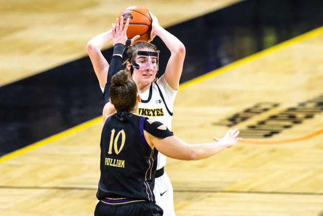 Iowa guard Kate Martin looks to pass as Northwestern guard Lindsey Pulliam (10) defends during the second half of a NCAA Big Ten Conference women's basketball game, Thursday, Jan. 28, 2021, at Carver-Hawkeye Arena in Iowa City, Iowa.
