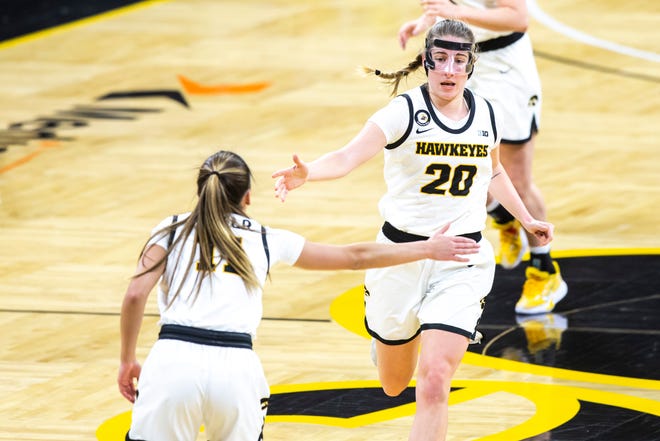 Iowa guard Kate Martin (20) celebrates with teammate Iowa guard Megan Meyer, left, after making a 3-point basket during the first half of a NCAA Big Ten Conference women's basketball game, Thursday, Jan. 28, 2021, at Carver-Hawkeye Arena in Iowa City, Iowa.