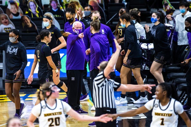 Northwestern head coach Joe McKeown talks with players heading into a timeout during the second half of a NCAA Big Ten Conference women's basketball game, Thursday, Jan. 28, 2021, at Carver-Hawkeye Arena in Iowa City, Iowa.