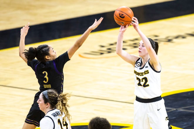 Iowa guard Caitlin Clark (22) attempts a 3-point basket as Northwestern's Sydney Wood (3) defends during the second half of a NCAA Big Ten Conference women's basketball game, Thursday, Jan. 28, 2021, at Carver-Hawkeye Arena in Iowa City, Iowa.