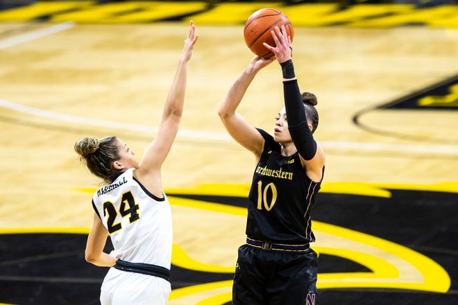 Northwestern guard Lindsey Pulliam (10) makes a basket as Iowa guard Gabbie Marshall (24) defends during the first half of a NCAA Big Ten Conference women's basketball game, Thursday, Jan. 28, 2021, at Carver-Hawkeye Arena in Iowa City, Iowa.