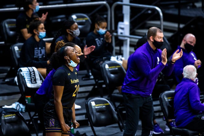 Northwestern forward Paige Mott (20) celebrates on the bench with teammates during the first half of a NCAA Big Ten Conference women's basketball game, Thursday, Jan. 28, 2021, at Carver-Hawkeye Arena in Iowa City, Iowa.
