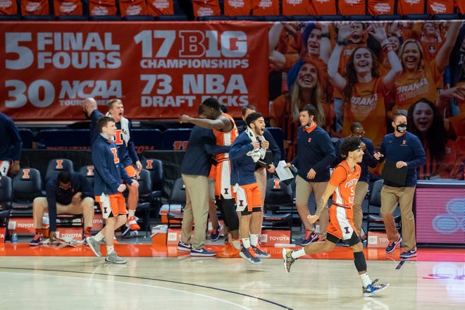 Jan 29, 2021; Champaign, Illinois, USA; The Illinois Fighting Illini celebrate their victory over the Iowa Hawkeyes at the State Farm Center.