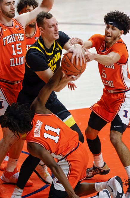 CHAMPAIGN, IL - JANUARY 29: Jack Nunge #2 of the Iowa Hawkeyes fights for the ball with Ayo Dosunmu #11 and Andre Curbelo #5 of the Illinois Fighting Illini at State Farm Center on January 29, 2021 in Champaign, Illinois.