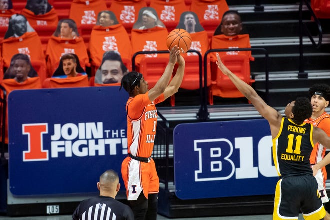 Jan 29, 2021; Champaign, Illinois, USA; Illinois Fighting Illini guard Trent Frazier (1) makes a three point basket against the Iowa Hawkeyes guard Tony Perkins, right, during the second half at the State Farm Center.
