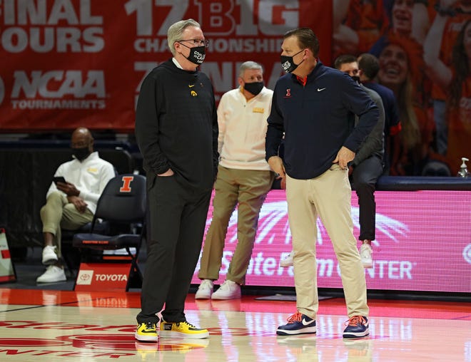 Iowa Hawkeyes head coach Fran McCaffery talks with Illinois Fighting Illini head coach Brad Underwood before their game during "Coaches vs. Cancer Suits And Sneakers Week," Friday, Jan. 29, 2021, at the State Farm Center in Champaign, Illinois.