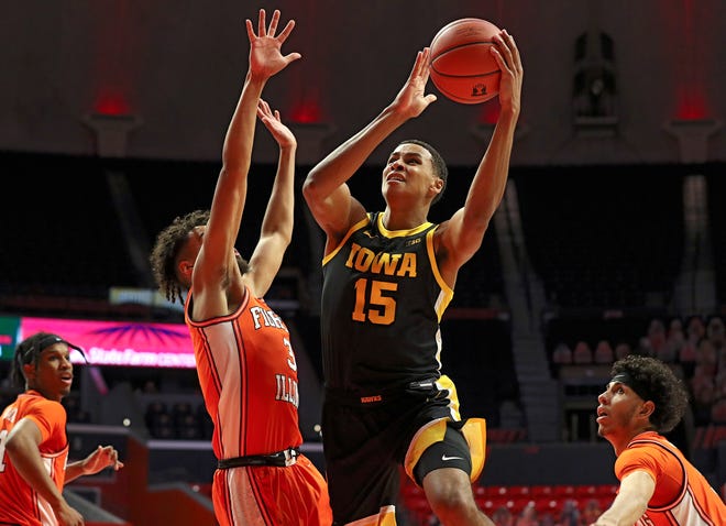 Iowa Hawkeyes forward Keegan Murray (15) puts up a shot as Illinois' Jacob Grandison, left, defends during the first half of their game, Friday, January 29, 2021, at the State Farm Center in Champaign, Illinois.