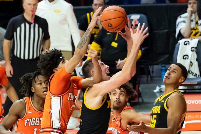 Jan 29, 2021; Champaign, Illinois, USA; Illinois Fighting Illini guard Andre Curbelo (5) and Iowa Hawkeyes guard Joe Wieskamp (middle) battle for a rebound during the second half at the State Farm Center.