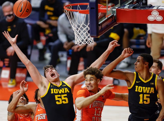 CHAMPAIGN, IL - JANUARY 29: Luka Garza #55 of the Iowa Hawkeyes reaches for the rebound with teammate Keegan Murray #15 of the Iowa Hawkeyes during the first half against Benjamin Bosmans-Verdonk #13 of the Illinois Fighting Illini at State Farm Center on January 29, 2021 in Champaign, Illinois.