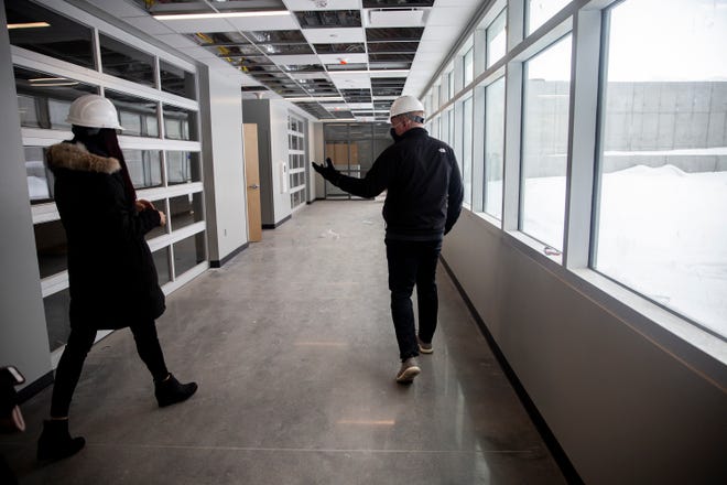 Principal Dr. Fairouz Bishara and Chief Operations Officer Kirk Johnson walk past art rooms in the new Waukee Northwest High School on Monday, Feb. 1, 2021, in Waukee.