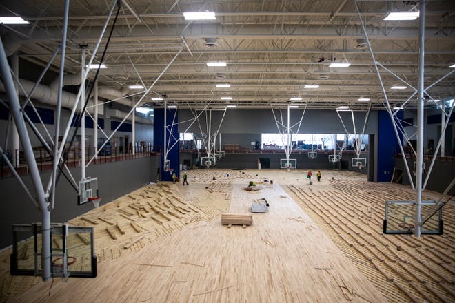 The gym floor installation is underway at Waukee's Northwest High School on Monday, Feb. 1, 2021, in Waukee.