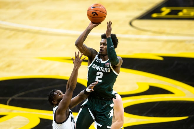 Michigan State guard Rocket Watts (2) makes a basket as Iowa guard Joe Toussaint, left, defends during a NCAA Big Ten Conference men's basketball game, Tuesday, Feb. 2, 2021, at Carver-Hawkeye Arena in Iowa City, Iowa.