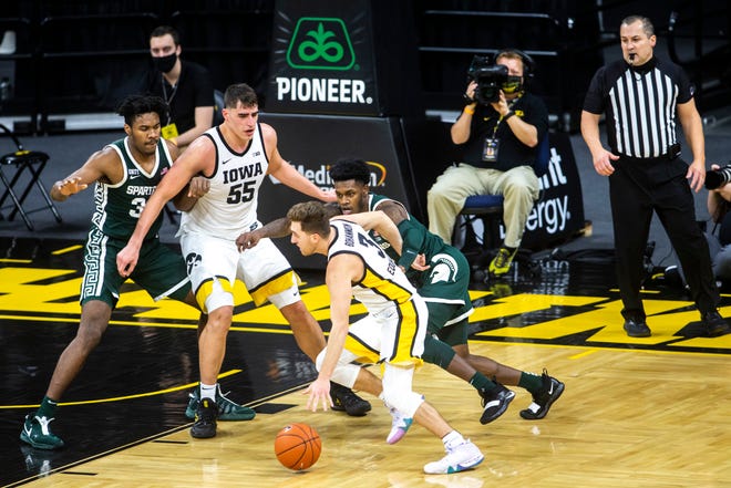Iowa guard Jordan Bohannon dribbles as Michigan State guard Rocket Watts, right, defends during a NCAA Big Ten Conference men's basketball game, Tuesday, Feb. 2, 2021, at Carver-Hawkeye Arena in Iowa City, Iowa.
