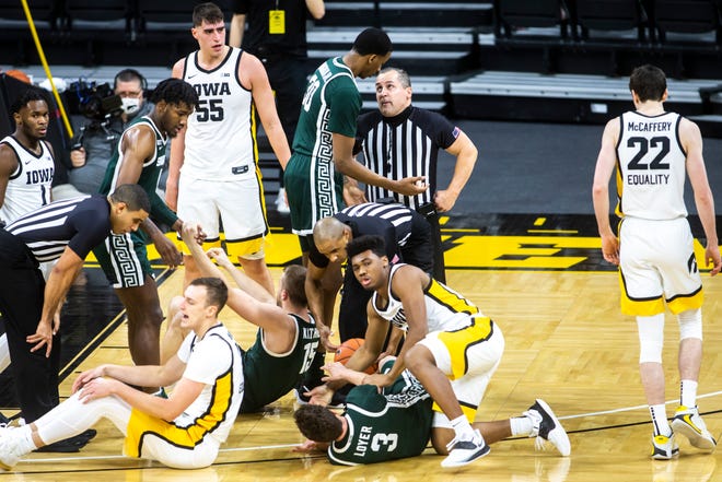 Iowa guard Tony Perkins (11) battles for a jump ball against Michigan State guard Foster Loyer (3) during a NCAA Big Ten Conference men's basketball game, Tuesday, Feb. 2, 2021, at Carver-Hawkeye Arena in Iowa City, Iowa.