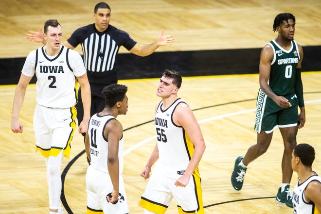 Iowa center Luka Garza (55) celebrates with Iowa guard Tony Perkins (11) during a NCAA Big Ten Conference men's basketball game against Michigan State, Tuesday, Feb. 2, 2021, at Carver-Hawkeye Arena in Iowa City, Iowa.