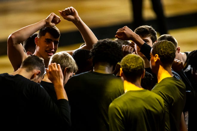Iowa center Luka Garza, left, huddles up with teammates before a NCAA Big Ten Conference men's basketball game against Michigan State, Tuesday, Feb. 2, 2021, at Carver-Hawkeye Arena in Iowa City, Iowa.