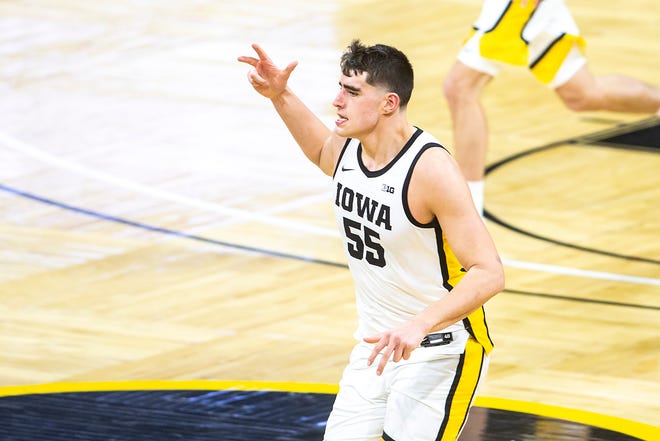 Iowa center Luka Garza (55) reacts after making a 3-point basket during a NCAA Big Ten Conference men's basketball game against Michigan State, Tuesday, Feb. 2, 2021, at Carver-Hawkeye Arena in Iowa City, Iowa.