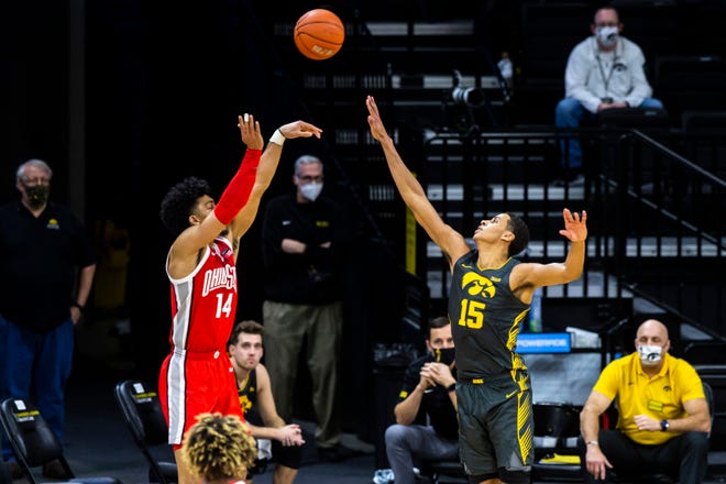 Ohio State forward Justice Sueing (14) makes a 3-point basket as Iowa forward Keegan Murray (15) defends during a NCAA Big Ten Conference men's basketball game, Thursday, Feb. 4, 2021, at Carver-Hawkeye Arena in Iowa City, Iowa.