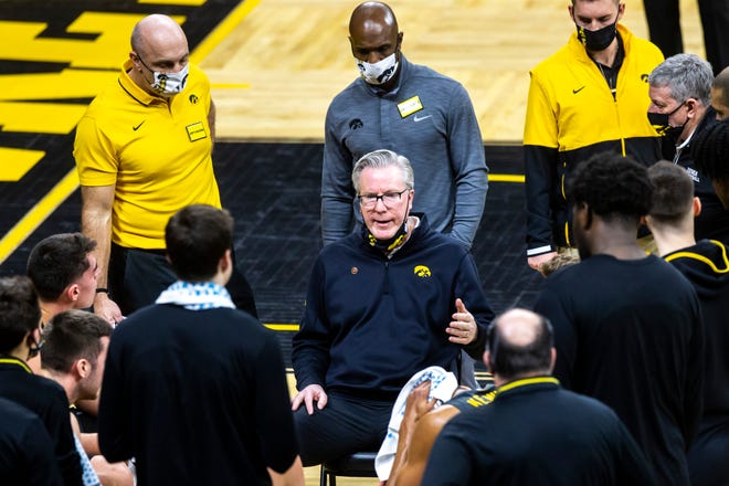 Iowa head coach Fran McCaffery talks with players in a timeout during a NCAA Big Ten Conference men's basketball game, Thursday, Feb. 4, 2021, at Carver-Hawkeye Arena in Iowa City, Iowa.