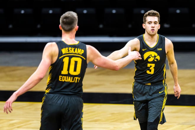 Iowa guard Jordan Bohannon (3) celebrates with teammate Joe Wieskamp (10) after making a 3-point basket in the first half during a NCAA Big Ten Conference men's basketball game against Ohio State, Thursday, Feb. 4, 2021, at Carver-Hawkeye Arena in Iowa City, Iowa.