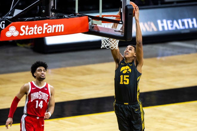Iowa forward Keegan Murray (15) dunks the ball as Ohio State forward Justice Sueing (14) defends during a NCAA Big Ten Conference men's basketball game, Thursday, Feb. 4, 2021, at Carver-Hawkeye Arena in Iowa City, Iowa.