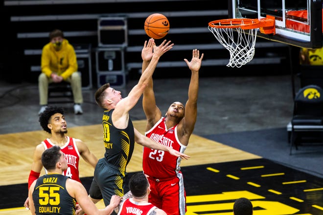 Iowa's Joe Wieskamp (10) makes a basket as Ohio State forward Zed Key (23) defends during a NCAA Big Ten Conference men's basketball game, Thursday, Feb. 4, 2021, at Carver-Hawkeye Arena in Iowa City, Iowa.