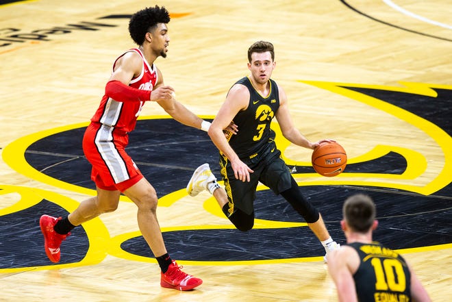 Iowa guard Jordan Bohannon (3) takes the ball up court as Ohio State forward Justice Sueing, left, defends during a NCAA Big Ten Conference men's basketball game, Thursday, Feb. 4, 2021, at Carver-Hawkeye Arena in Iowa City, Iowa.