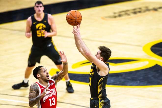 Iowa guard Jordan Bohannon (3) attempts a 3-point basket as Ohio State guard CJ Walker (13) during a NCAA Big Ten Conference men's basketball game, Thursday, Feb. 4, 2021, at Carver-Hawkeye Arena in Iowa City, Iowa.