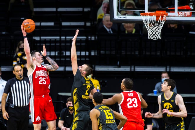 Ohio State forward Kyle Young (25) makes a basket as Iowa forward Jack Nunge (2) defends during a NCAA Big Ten Conference men's basketball game, Thursday, Feb. 4, 2021, at Carver-Hawkeye Arena in Iowa City, Iowa.