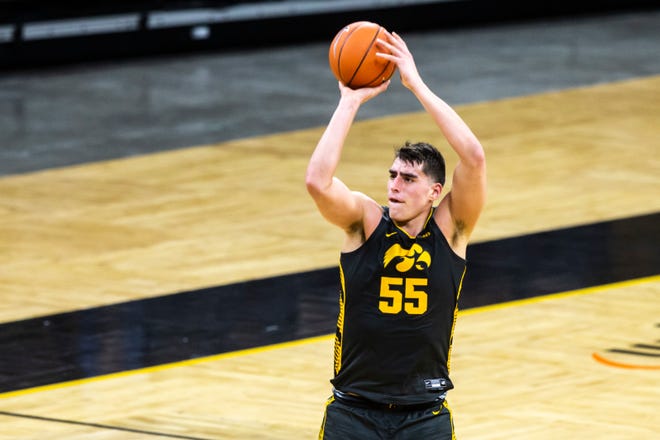 Iowa center Luka Garza (55) makes a 3-point basket during  the second half of a NCAA Big Ten Conference men's basketball game against Ohio State, Thursday, Feb. 4, 2021, at Carver-Hawkeye Arena in Iowa City, Iowa.