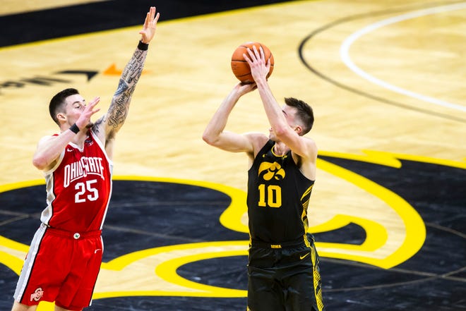 Iowa's Joe Wieskamp (10) makes a 3-point basket as Ohio State forward Kyle Young (25) defends during a NCAA Big Ten Conference men's basketball game, Thursday, Feb. 4, 2021, at Carver-Hawkeye Arena in Iowa City, Iowa.