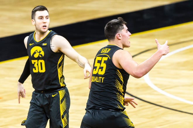 Iowa center Luka Garza (55) reacts after making a 3-point basket during  the second half of a NCAA Big Ten Conference men's basketball game against Ohio State, Thursday, Feb. 4, 2021, at Carver-Hawkeye Arena in Iowa City, Iowa.